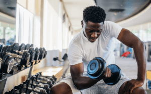 man lifting weights in gym